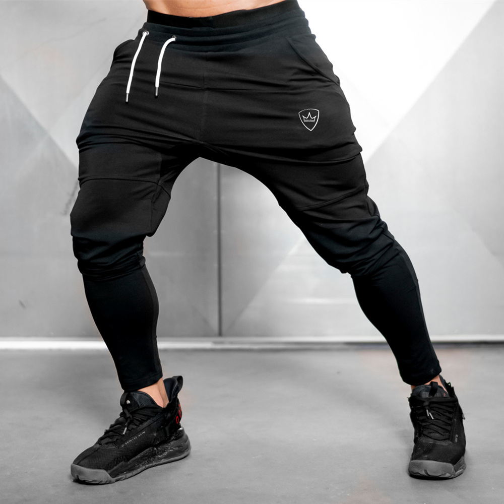 https://d3thqe68ymbqps.cloudfront.net/1068603-large_default/gym-sweatpants-jogger-pants-men-casual-black-trousers-male-fitness-spo.jpg